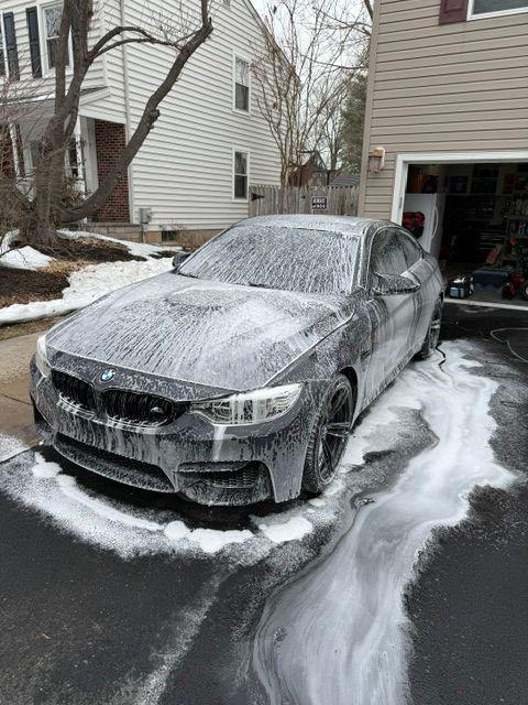 BMW M4 covered in foam during a hand wash
